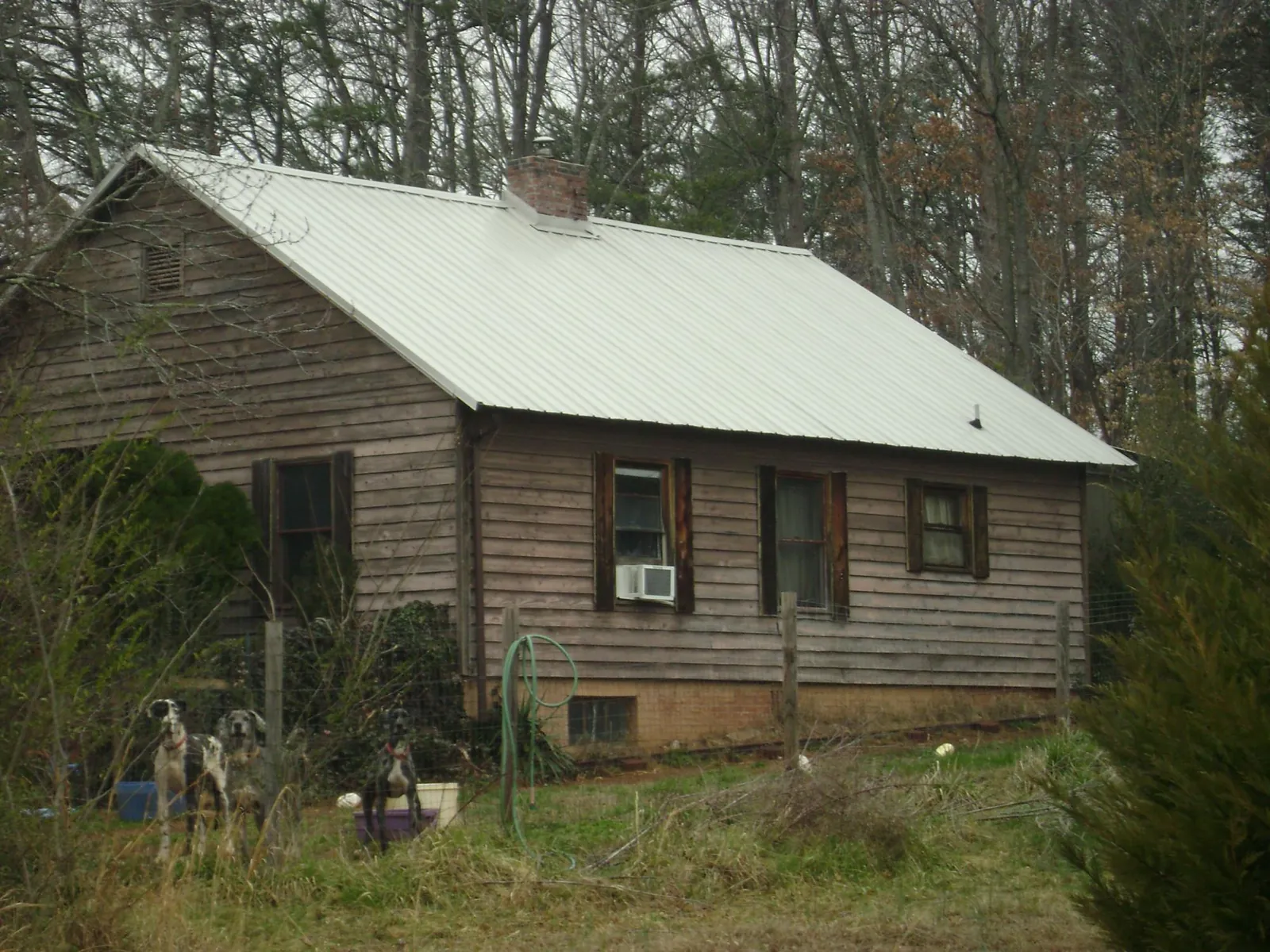 White metal roof on an old wood sided farmhouse, from a Metal Roof Installation job in Richmond Hill