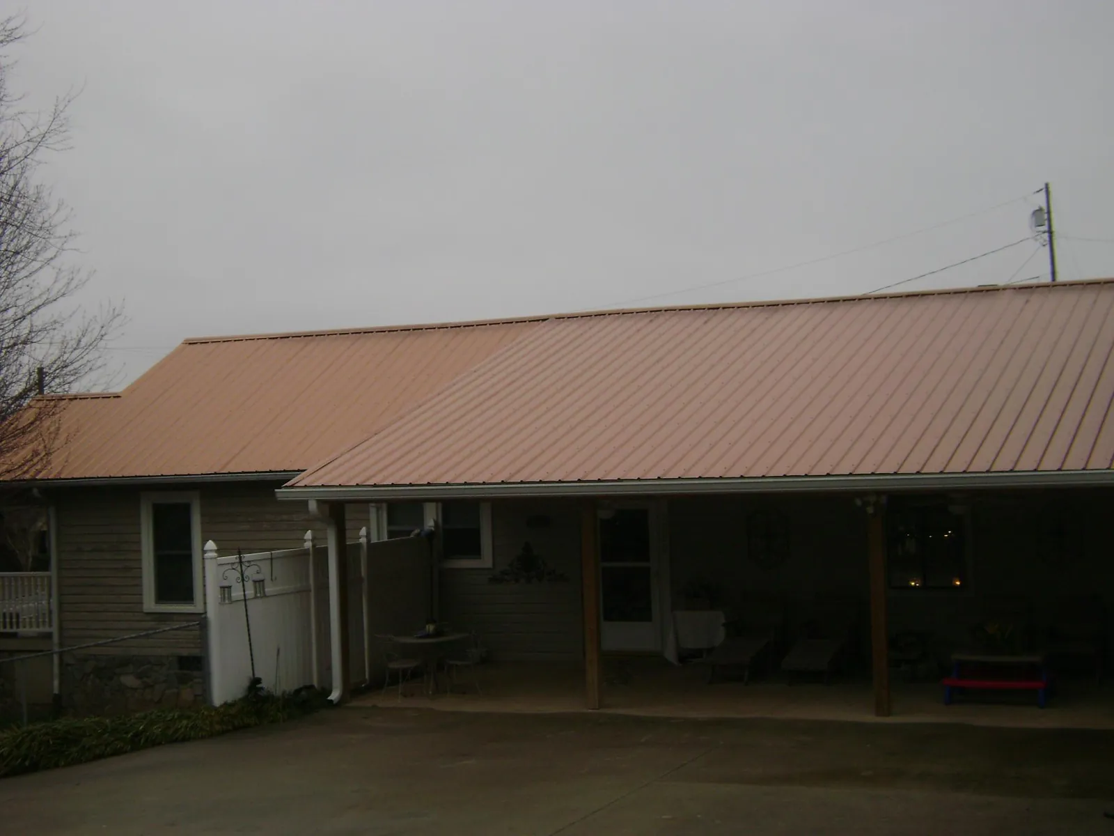 Copper toned metal roof over a wide covered patio in Richmond Hill